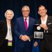 Gene Hayman receiving Ambassador award with Fran Hill, Chairwoman of the Board and Peter F. Dumont, ATCA CEO & President